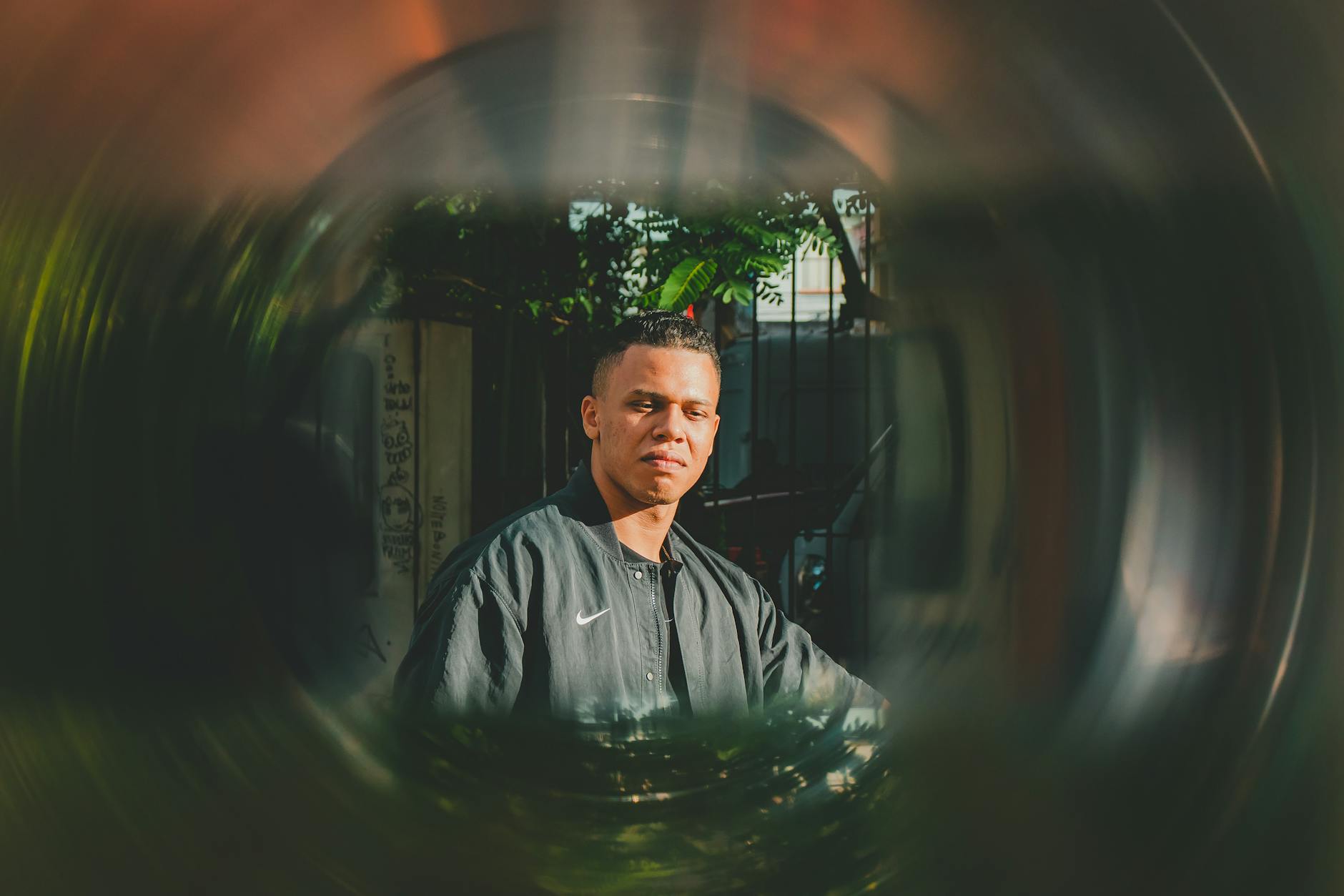 Artistic portrait of a man outdoors in São Paulo, Brasil with a creative lens effect capturing natural light.