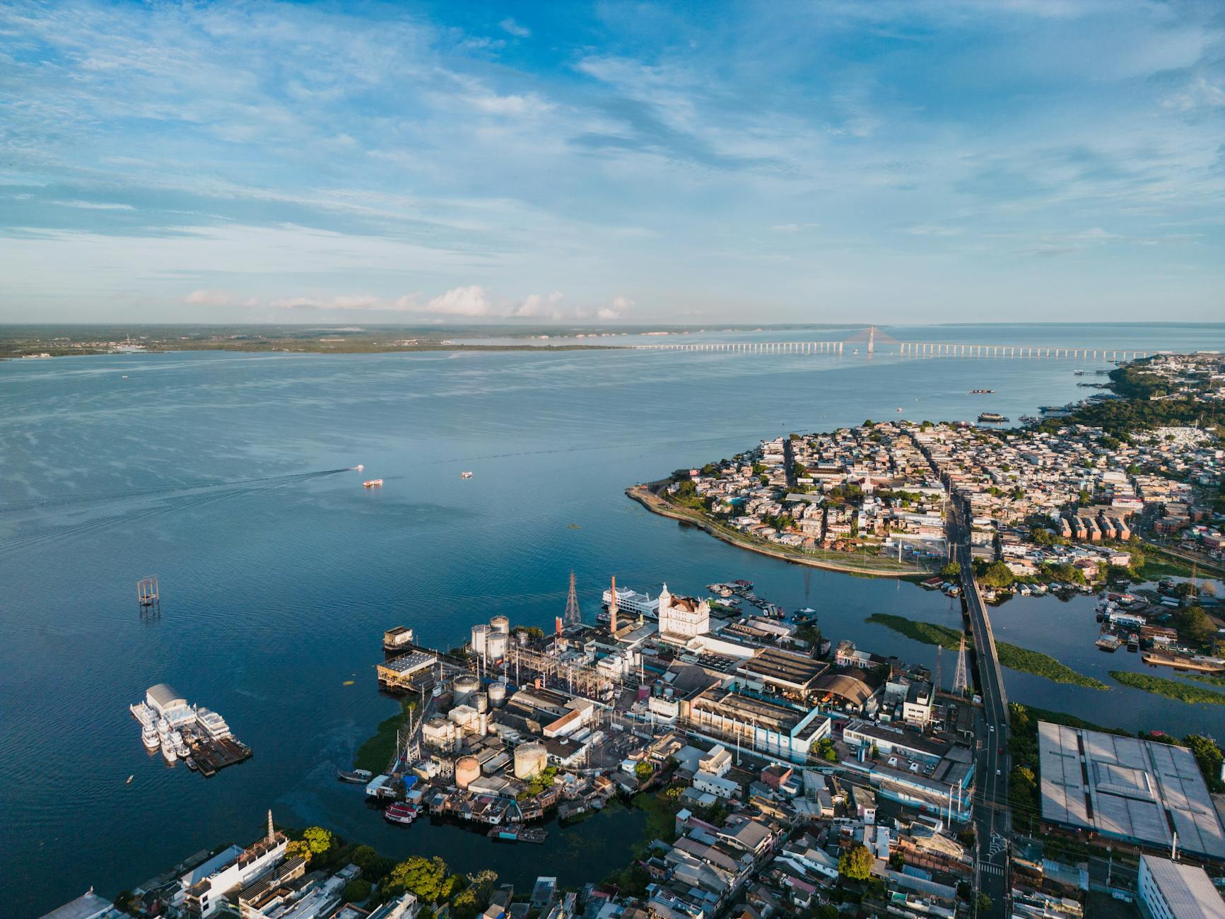 Stunning aerial view of Manaus, Brazil with Rio Negro Bridge in the distance.