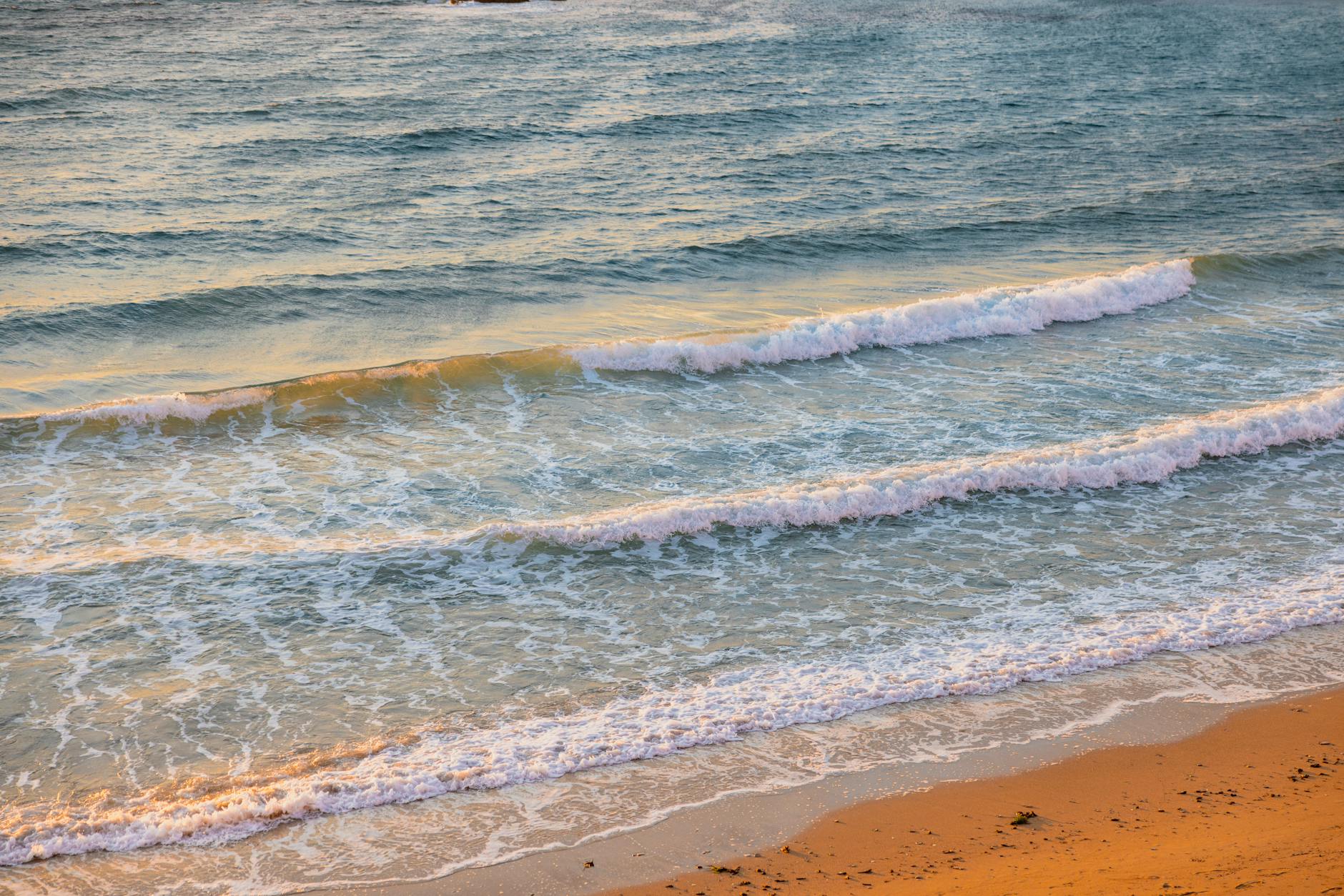 Beautiful waves and golden sand along Gallipoli's coast, captured during a serene sunset.