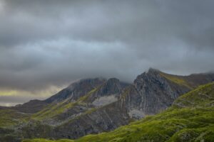 Breathtaking panorama of Montenegro's Durmitor peaks covered in mist and clouds.