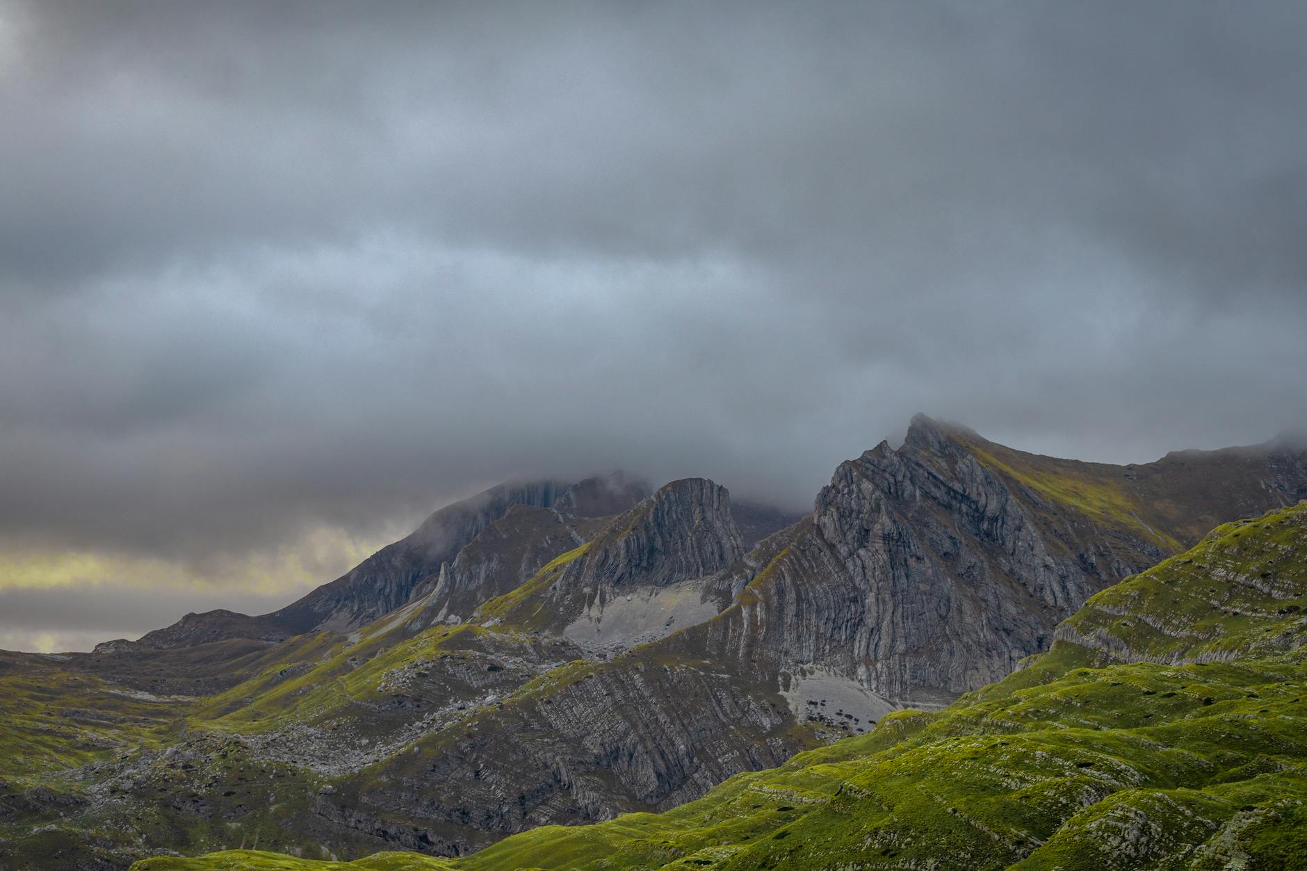 Breathtaking panorama of Montenegro's Durmitor peaks covered in mist and clouds.