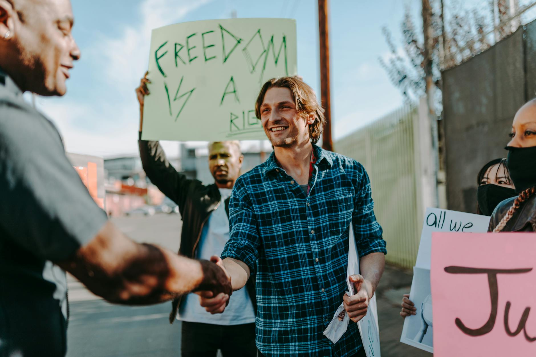 A group of diverse adults participating in a peaceful protest advocating for civil rights and freedom.