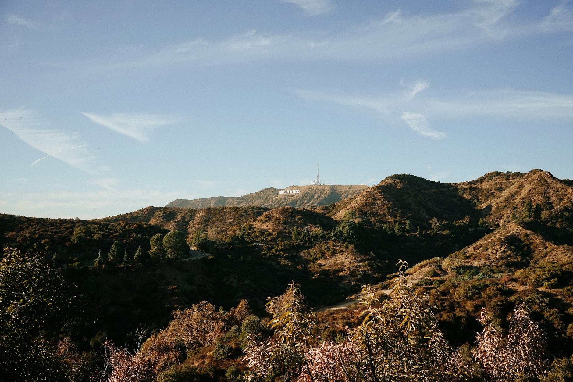 Beautiful landscape view of the Hollywood Hills showcasing the iconic Hollywood sign under a clear blue sky.