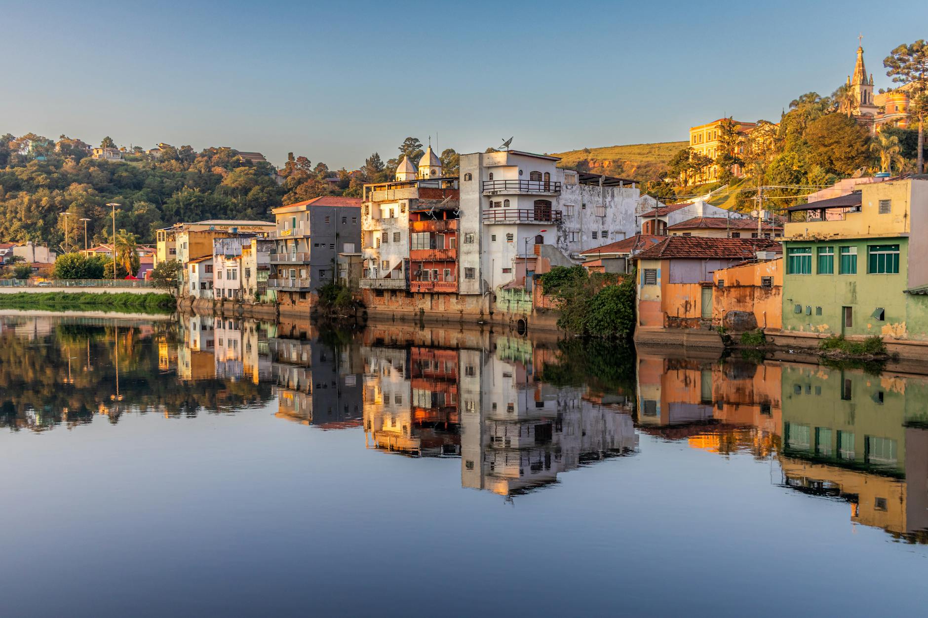 Scenic view of colorful riverside buildings in São Paulo, Brazil reflecting in serene waters.